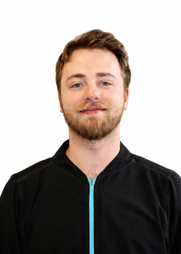 Photo of white male in black jacket with blue zipper