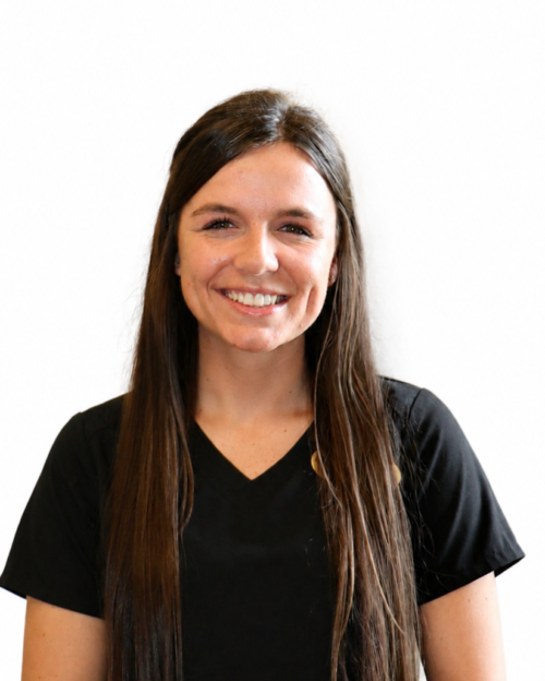 Photo of woman with long brown hair in a black scrub top